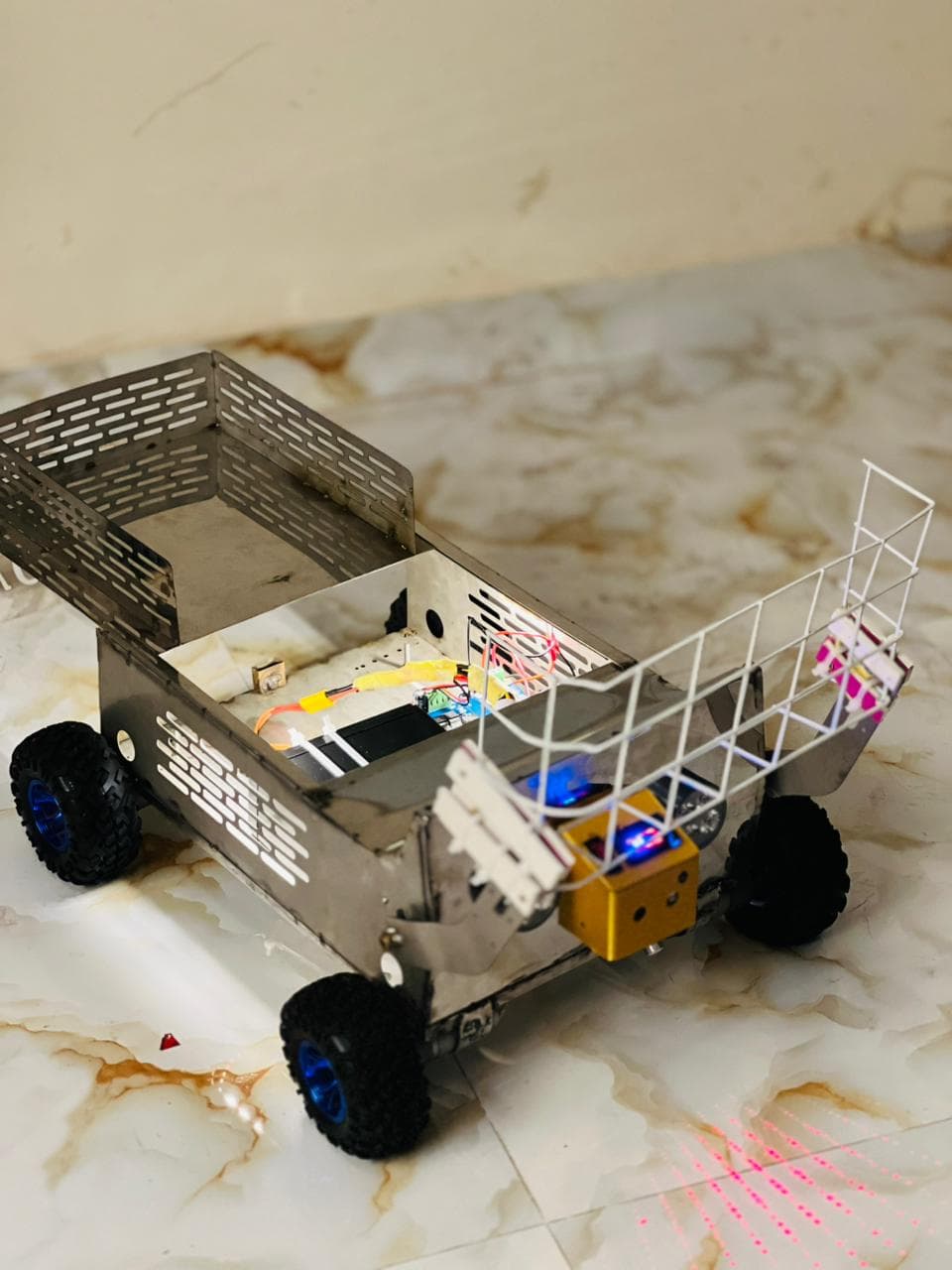 The white wire collection scoop mounted on the front of the rover