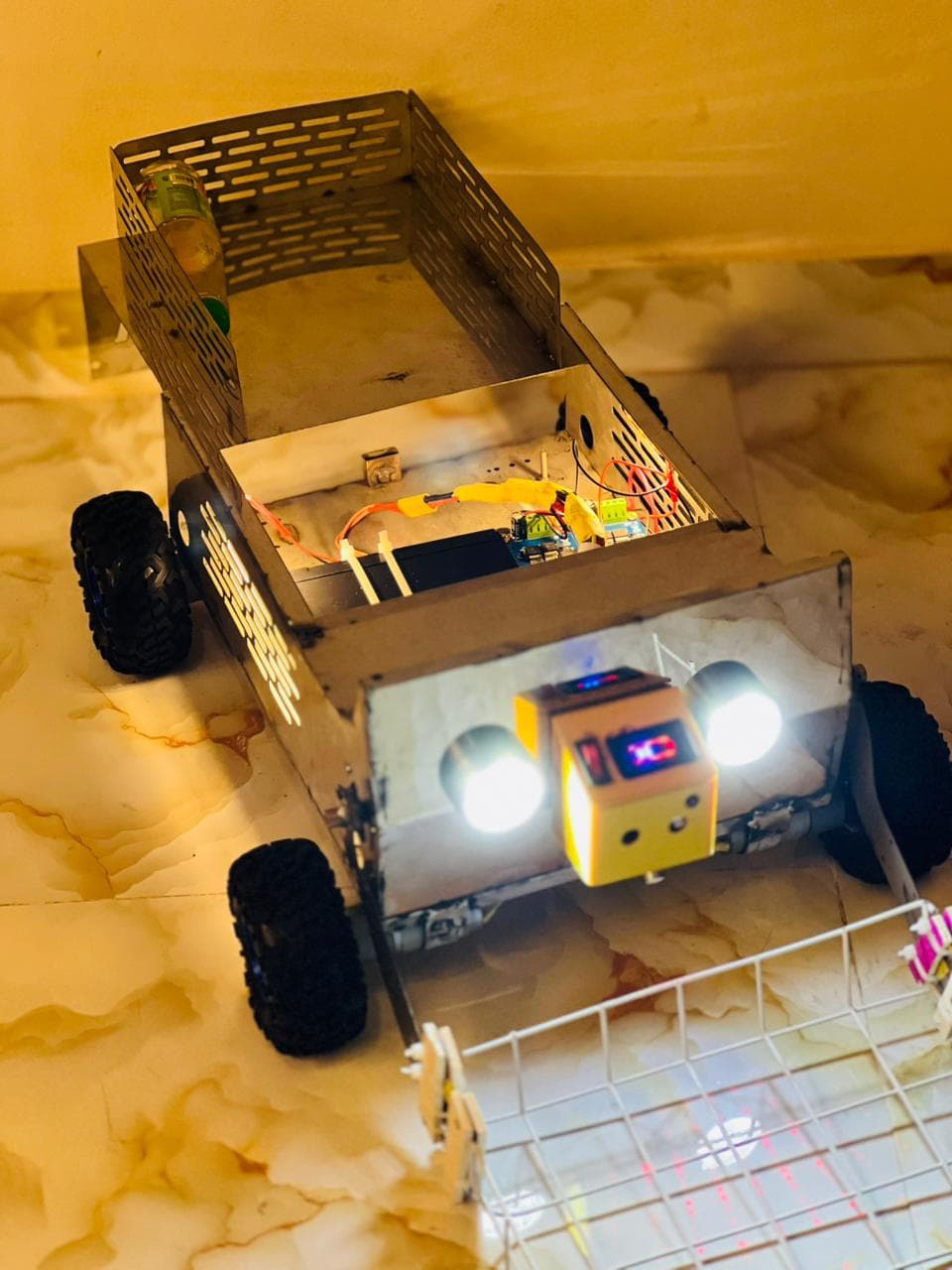 The Paradox cleaning robot — a stainless-steel rover with an open cargo bed